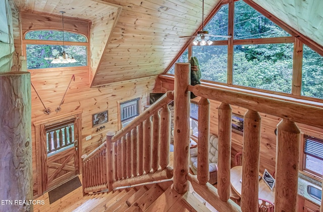 2261 Beach Front Dr, Sevierville, TN 37876 - staircase featuring high vaulted ceiling, hardwood / wood-style flooring, wood walls, wood ceiling, and a chandelier