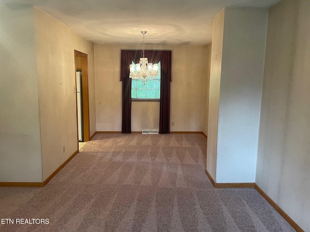 217 Newport Rd Unit 5, Knoxville, TN 37934 - unfurnished dining area featuring a chandelier, carpet floors, and baseboards