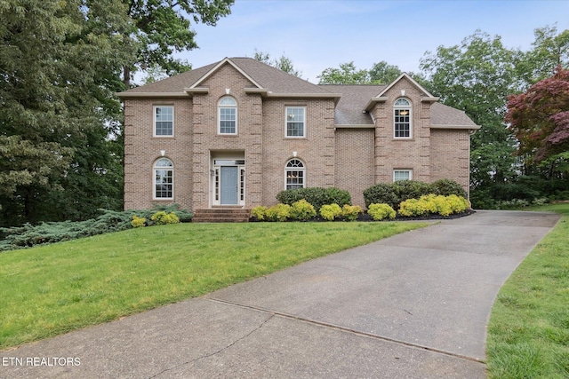 1247 Hearthstone Ln, Knoxville, TN 37923 - view of front of home featuring brick siding, a front lawn, roof with shingles, and driveway