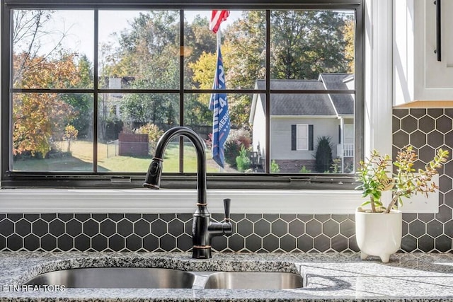 236 Stratford Dr, Cookeville, TN 38506 - kitchen view of a sink, tasteful backsplash, white cabinetry, and light stone counters