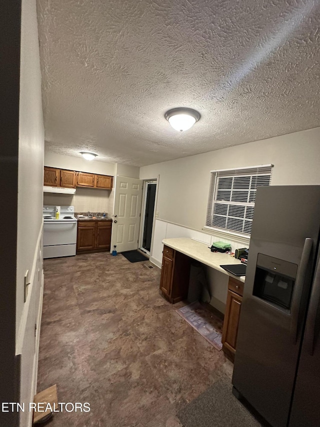 105 Mudlick Rd, Middlesboro, KY 40965 - kitchen featuring white range with electric stovetop, stainless steel fridge, brown cabinetry, a textured ceiling, and light countertops