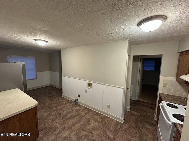105 Mudlick Rd, Middlesboro, KY 40965 - kitchen featuring white electric stove, freestanding refrigerator, and a textured ceiling