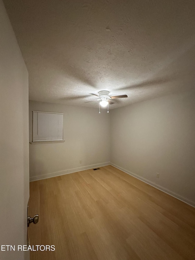 105 Mudlick Rd, Middlesboro, KY 40965 - spare room with a ceiling fan, light wood finished floors, a textured ceiling, and baseboards