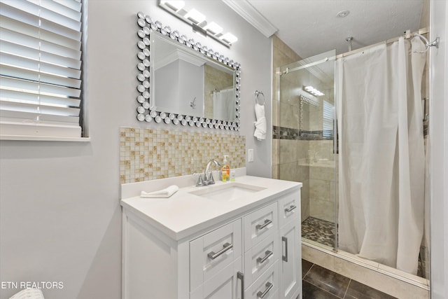 2837 Willa View Dr, Pigeon Forge, TN 37863 - bathroom featuring a shower stall, vanity, decorative backsplash, crown molding, and tile patterned floors