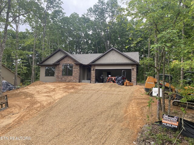 233 Albemarle Cir, Fairfield Glade, TN 38558 - craftsman-style house with driveway, a garage, and roof with shingles