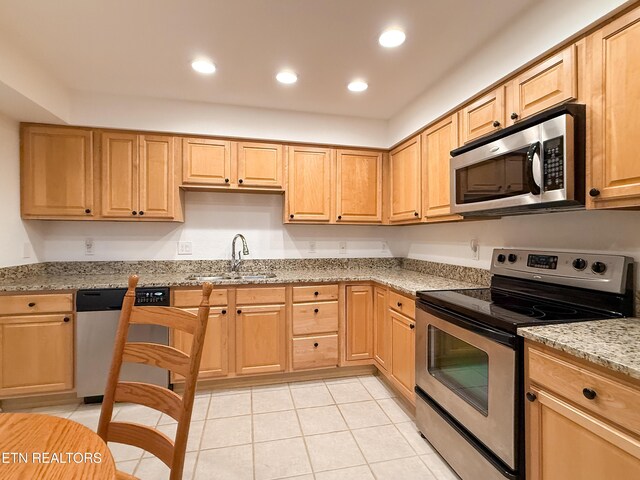 11104 Joiner Way, Knoxville, TN 37934 - kitchen featuring stainless steel appliances, a sink, light stone countertops, light tile patterned floors, and recessed lighting