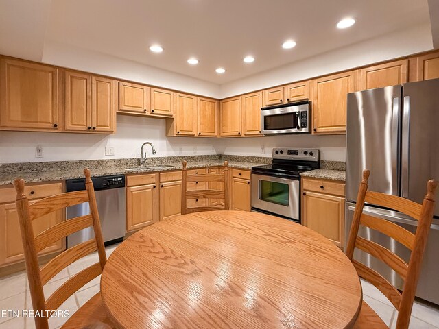 11104 Joiner Way, Knoxville, TN 37934 - kitchen featuring stainless steel appliances, recessed lighting, a sink, light tile patterned floors, and light stone counters