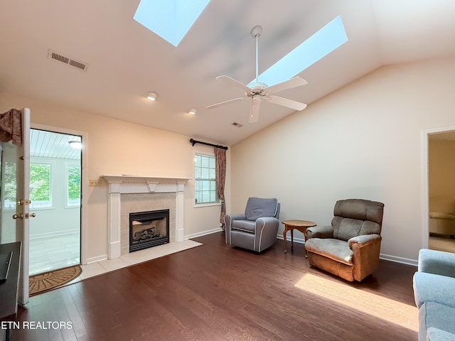 11104 Joiner Way, Knoxville, TN 37934 - living room featuring a skylight, lofted ceiling, wood finished floors, a tile fireplace, and baseboards