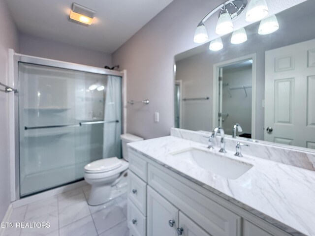 11104 Joiner Way, Knoxville, TN 37934 - bathroom featuring a stall shower, vanity, toilet, a walk in closet, and marble look tile flooring