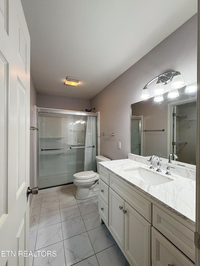 11104 Joiner Way, Knoxville, TN 37934 - bathroom featuring vanity, toilet, a shower with shower door, and marble look tiles