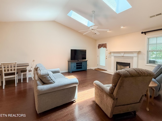 11104 Joiner Way, Knoxville, TN 37934 - living room featuring a skylight, vaulted ceiling, a tile fireplace, dark wood-type flooring, and baseboards