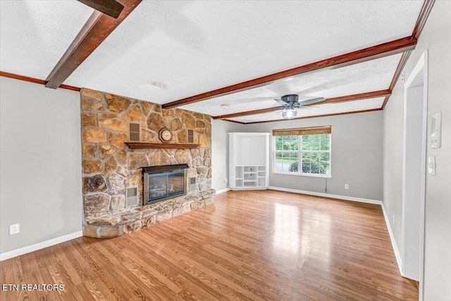 1413 Farrington Dr Unit 1, Knoxville, TN 37923 - unfurnished living room with beam ceiling, wood finished floors, ceiling fan, a stone fireplace, and baseboards