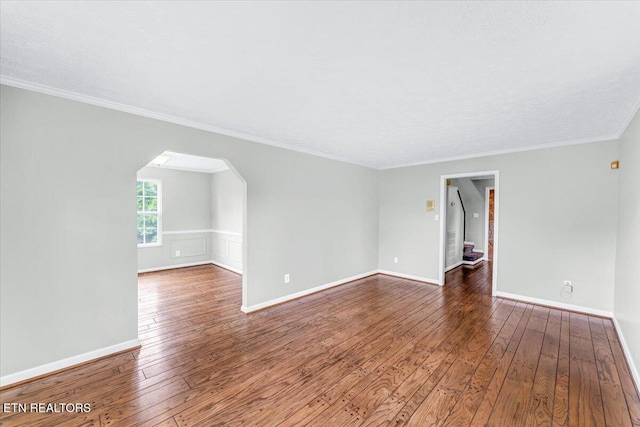 1413 Farrington Dr Unit 1, Knoxville, TN 37923 - empty room featuring wood-type flooring, arched walkways, crown molding, and baseboards