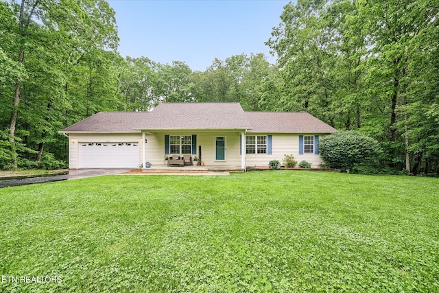 2236 Spruce Loop, Crossville, TN 38555 - single story home with an attached garage, driveway, a front yard, a porch, and a shingled roof