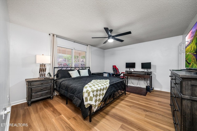 2236 Spruce Loop, Crossville, TN 38555 - bedroom featuring wood finished floors, baseboards, a textured ceiling, ceiling fan, and an office area