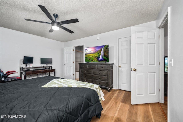 2236 Spruce Loop, Crossville, TN 38555 - bedroom featuring light wood finished floors, a textured ceiling, and ceiling fan