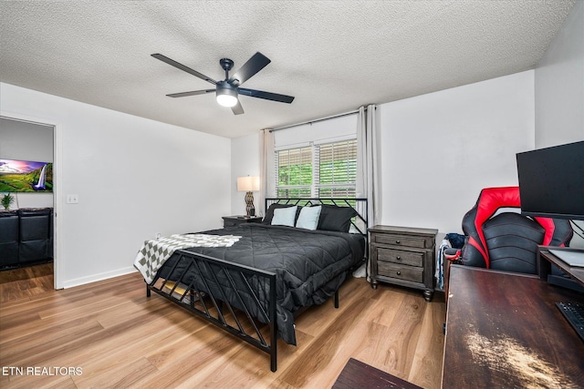 2236 Spruce Loop, Crossville, TN 38555 - bedroom with wood finished floors, a textured ceiling, a ceiling fan, and baseboards