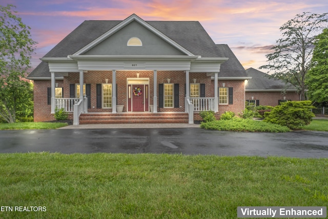 827 Knight Bridge Rd, Maryville, TN 37803 - greek revival inspired property featuring brick siding, asphalt driveway, covered porch, a lawn, and roof with shingles