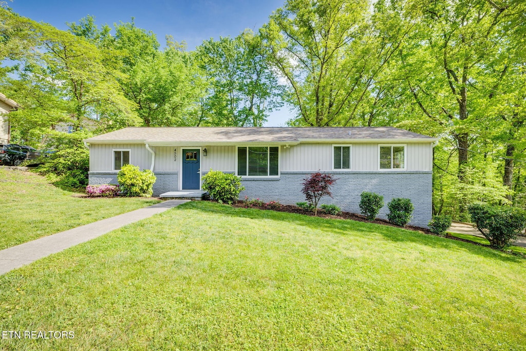 4502 Mockingbird Ln, Knoxville, TN 37918 - ranch-style home with brick siding, a front lawn, and roof with shingles