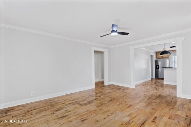 207 N Laurel Cir, Knoxville, TN 37912 - unfurnished living room with crown molding, a ceiling fan, light wood-style floors, and baseboards