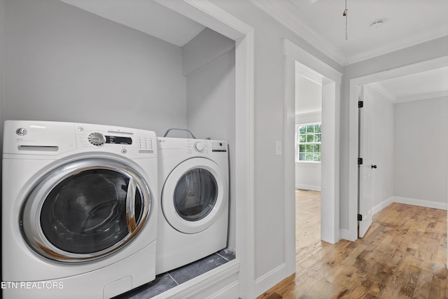207 N Laurel Cir, Knoxville, TN 37912 - washroom with washing machine and clothes dryer, crown molding, wood finished floors, and baseboards