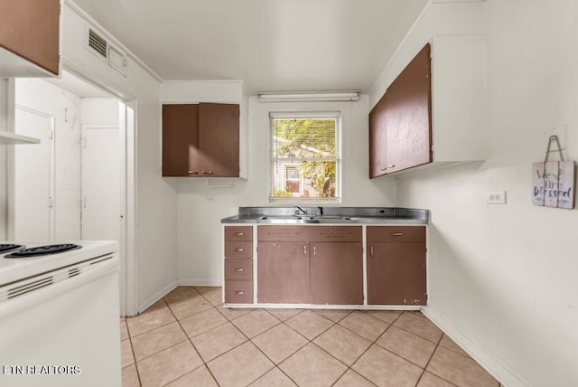 255 N Purdue Ave, Oak Ridge, TN 37830 - kitchen with white electric range oven, a sink, baseboards, light countertops, and light tile patterned floors