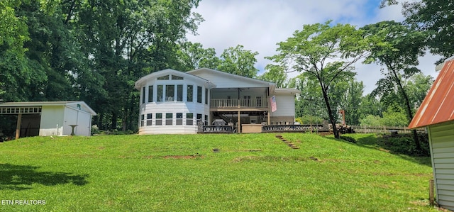 989 W Outer Dr, Oak Ridge, TN 37830 - rear view of property featuring a yard, a ceiling fan, a sunroom, and an outbuilding