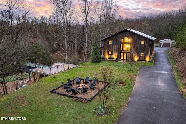1293 Laurel Lick Rd, Sevierville, TN 37862 - view of front of home with a detached garage, an outdoor fire pit, a yard, and driveway