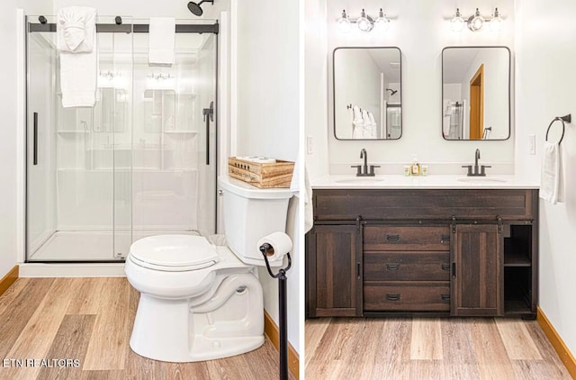 1293 Laurel Lick Rd, Sevierville, TN 37862 - bathroom featuring wood finished floors, a stall shower, toilet, double vanity, and baseboards