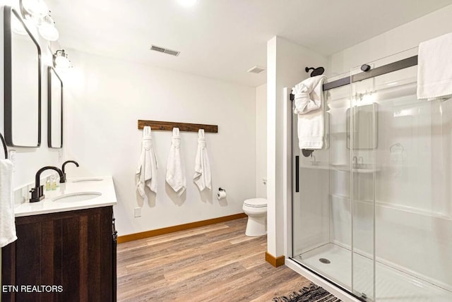 1293 Laurel Lick Rd, Sevierville, TN 37862 - full bath with wood finished floors, double vanity, a stall shower, toilet, and baseboards
