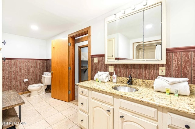 1293 Laurel Lick Rd, Sevierville, TN 37862 - full bathroom with a wainscoted wall, vanity, toilet, tile patterned flooring, and a shower with shower curtain