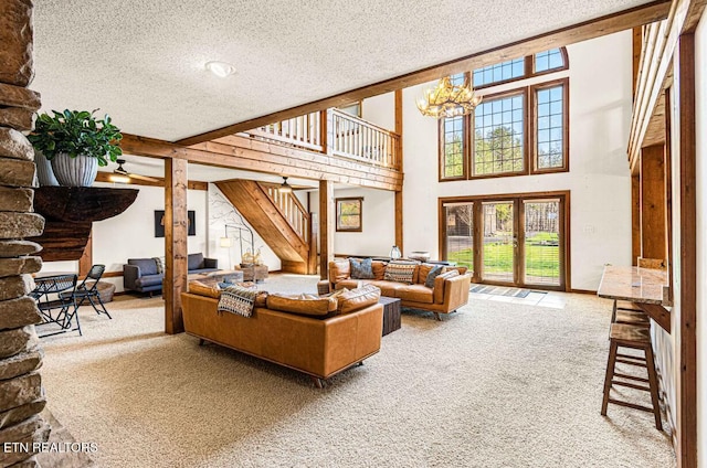 1293 Laurel Lick Rd, Sevierville, TN 37862 - carpeted living area with stairs, a textured ceiling, healthy amount of natural light, and a chandelier