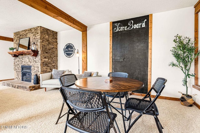1293 Laurel Lick Rd, Sevierville, TN 37862 - carpeted dining room featuring a fireplace, a textured ceiling, and beam ceiling