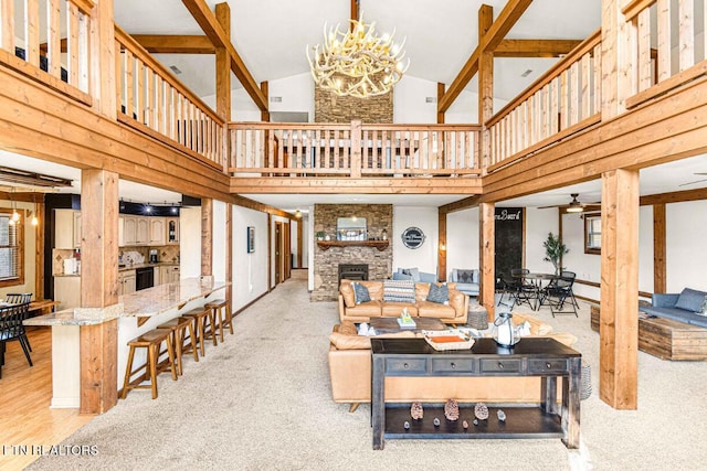 1293 Laurel Lick Rd, Sevierville, TN 37862 - carpeted living room with high vaulted ceiling, a fireplace, a chandelier, and a ceiling fan
