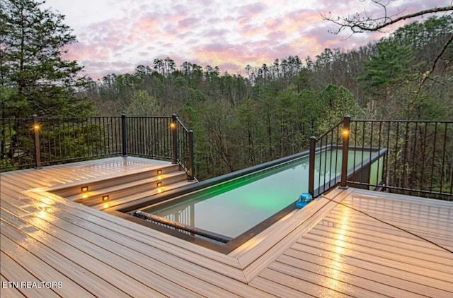 1293 Laurel Lick Rd, Sevierville, TN 37862 - deck at dusk featuring an outdoor pool
