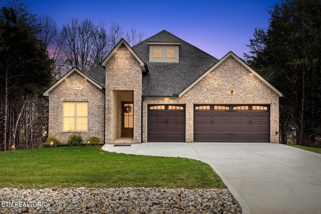 101 Dudala Way, Loudon, TN 37774 - view of front facade featuring a garage, roof with shingles, brick siding, driveway, and a lawn