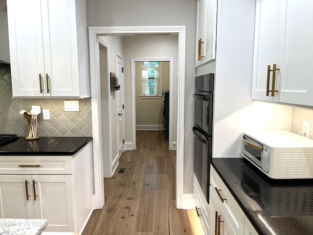 101 Dudala Way, Loudon, TN 37774 - kitchen with tasteful backsplash, white cabinets, wood-type flooring, and dark stone countertops