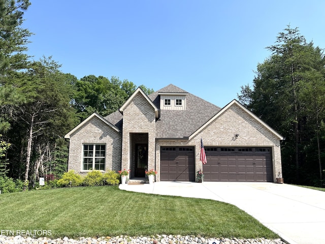 101 Dudala Way, Loudon, TN 37774 - view of front of home featuring a garage, brick siding, concrete driveway, and a front lawn