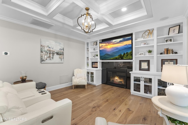 101 Dudala Way, Loudon, TN 37774 - living area featuring crown molding, wood finished floors, a glass covered fireplace, a chandelier, and built in shelves