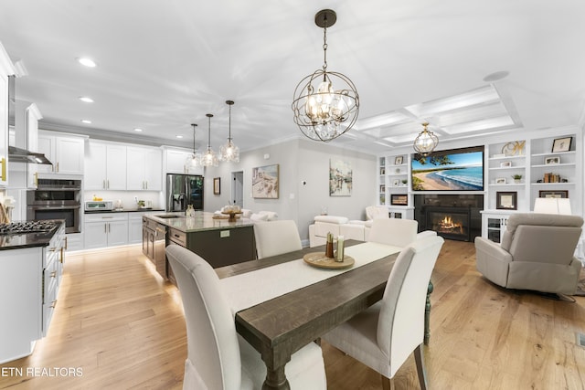 101 Dudala Way, Loudon, TN 37774 - dining space with a lit fireplace, a chandelier, crown molding, recessed lighting, and light wood-style flooring