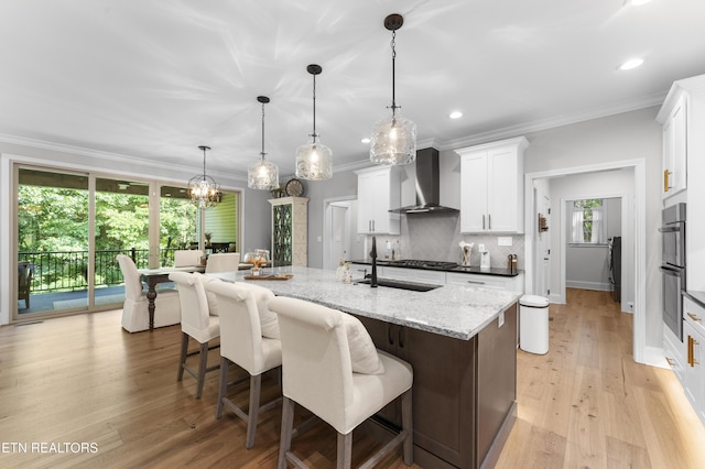 101 Dudala Way, Loudon, TN 37774 - kitchen with wall chimney range hood, white cabinets, a center island with sink, recessed lighting, and a breakfast bar