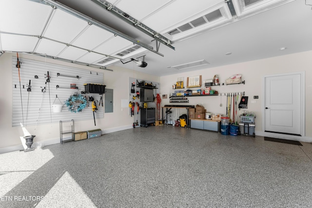 101 Dudala Way, Loudon, TN 37774 - garage featuring electric panel, a workshop area, and a garage door opener