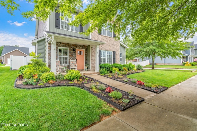 128 Hackberry St, Oak Ridge, TN 37830 - traditional home with a porch, board and batten siding, and stone siding