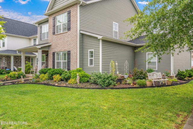 128 Hackberry St, Oak Ridge, TN 37830 - view of property exterior with a lawn and brick siding