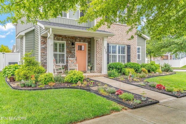 128 Hackberry St, Oak Ridge, TN 37830 - view of front facade featuring stone siding and a porch