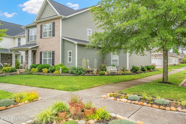 128 Hackberry St, Oak Ridge, TN 37830 - view of front of house with brick siding, a front yard, and roof with shingles