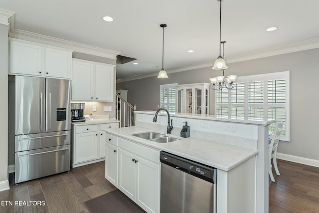 128 Hackberry St, Oak Ridge, TN 37830 - kitchen featuring stainless steel appliances, a sink, ornamental molding, dark wood-type flooring, and white cabinets