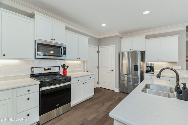 128 Hackberry St, Oak Ridge, TN 37830 - kitchen with stainless steel appliances, a sink, dark wood finished floors, crown molding, and white cabinetry