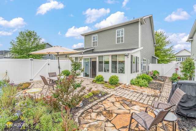 128 Hackberry St, Oak Ridge, TN 37830 - back of property with a gate, a patio, a sunroom, a fenced backyard, and roof with shingles
