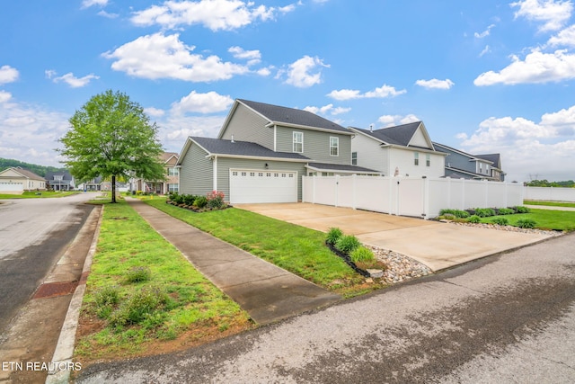 128 Hackberry St, Oak Ridge, TN 37830 - traditional home with a residential view, concrete driveway, and a garage